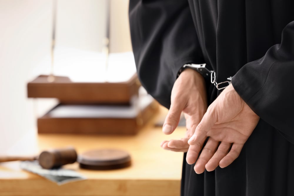 man handcuffed in court