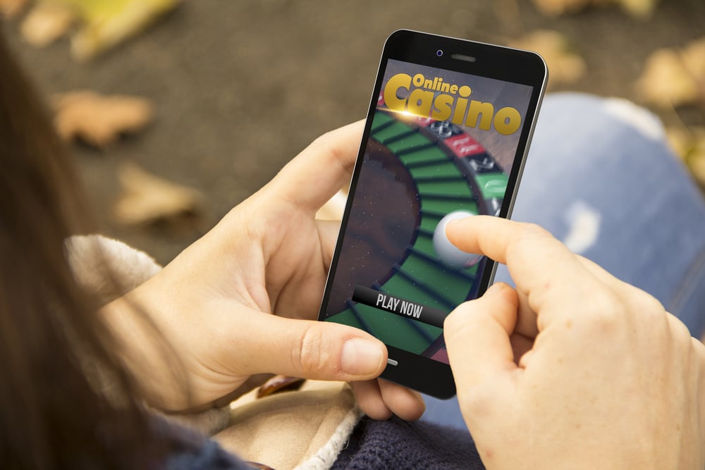 woman gambling at online casino on mobile