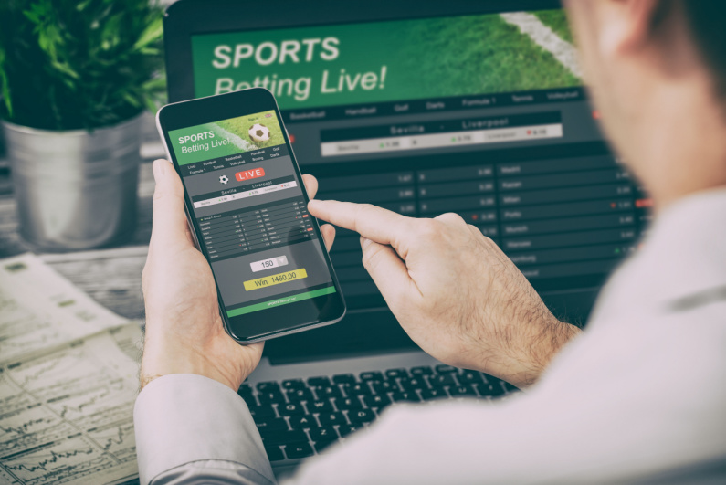 A man betting on sports on his phone