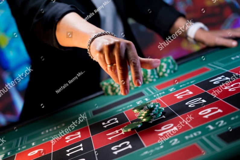 Woman putting down roulette bet