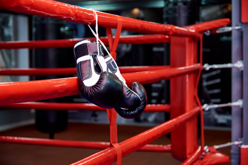 Boxing gloves hanging on a boxing ring