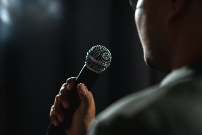 Comedian holding microphone