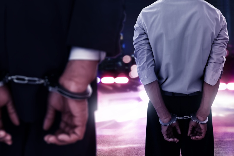 Two men in handcuffs