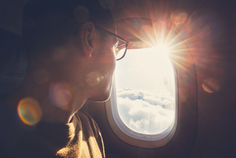 Man looking out an airplane window