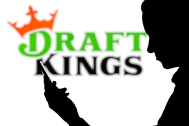 DraftKings symbol with person on phone