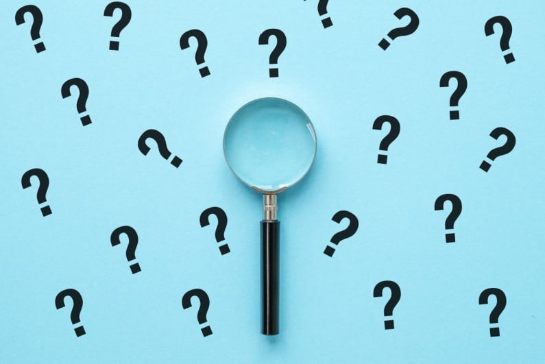 Magnifying glass with question marks