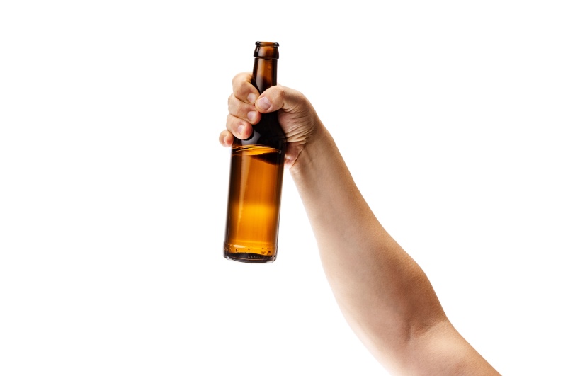 Hand holding beer bottle