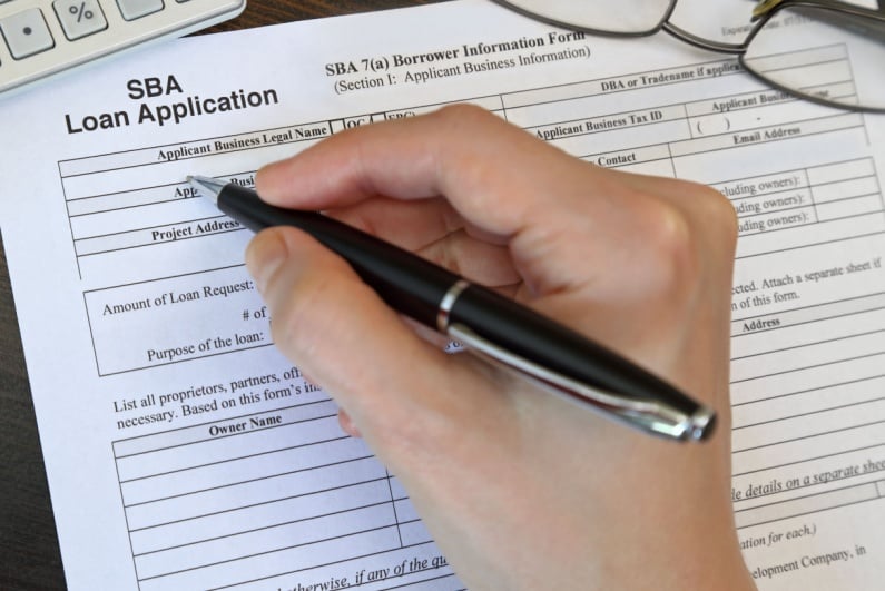 Person filling out SBA loan application