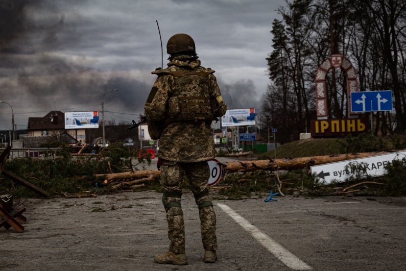 Soldier surveys ruins in Ukraine War