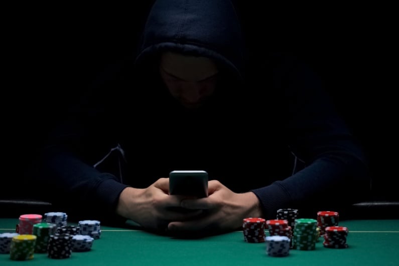 Person on phone at poker table