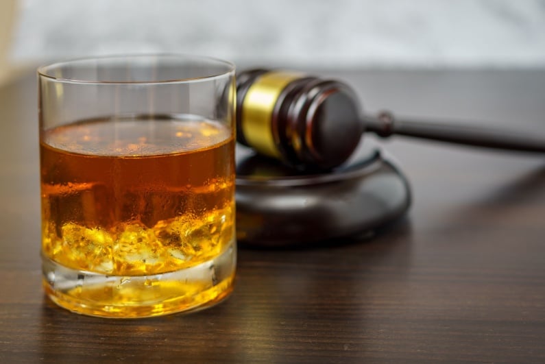 Whisky and wooden gavel