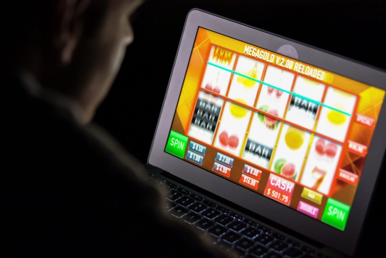 Man playing online slots on his laptop