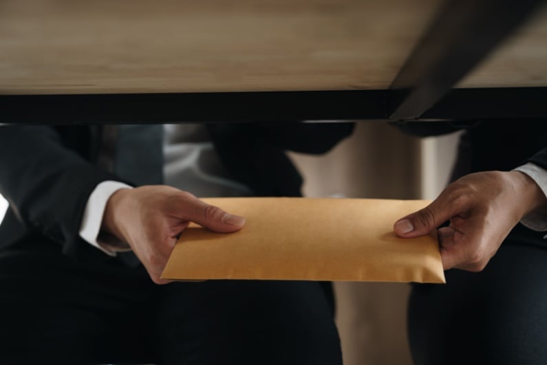 Passing envelope under the table