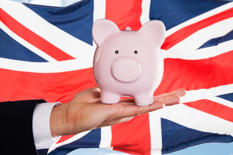 Piggy bank in front of UK flag