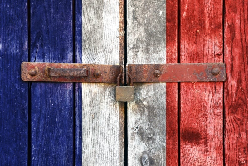 Locked wooden doors painted like French flag