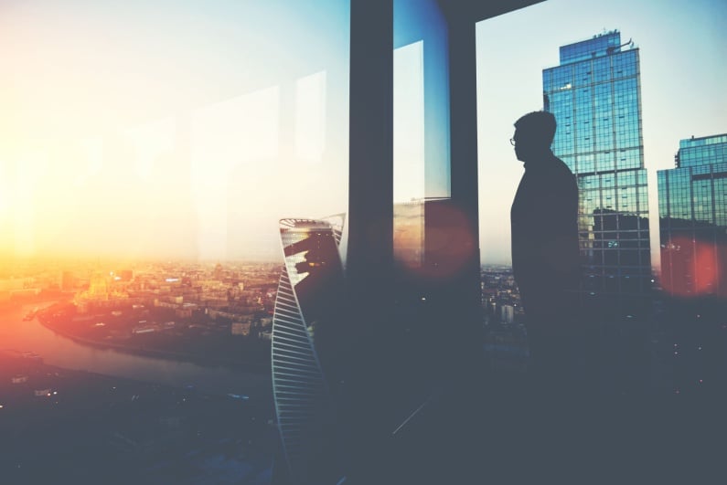 Banker looking out of office