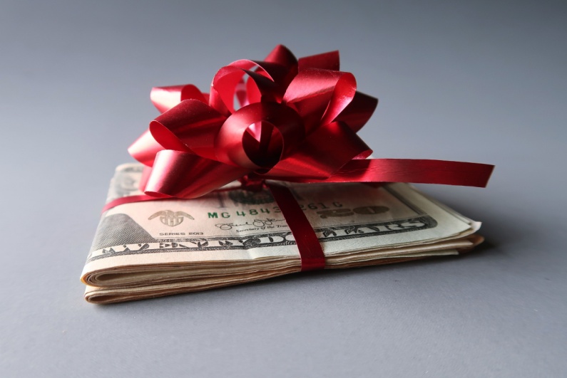 Cash wrapped with red bow