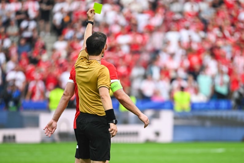 Referee showing yellow card