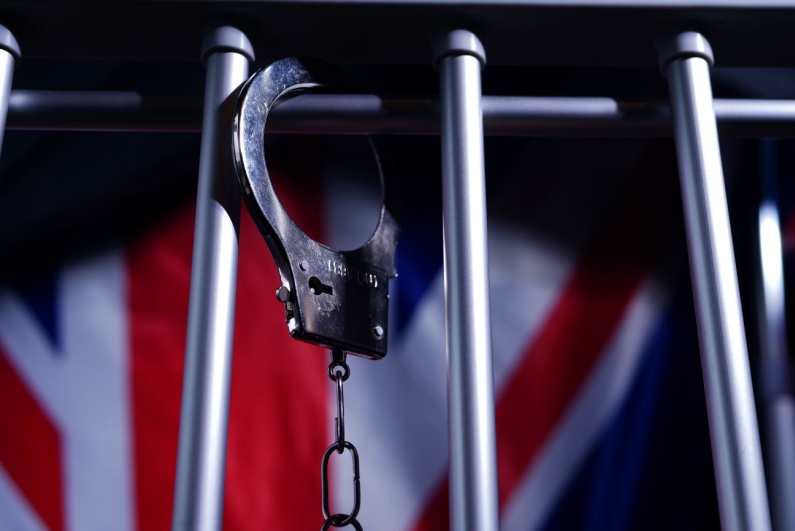 Handcuffs hanging from jail cell door