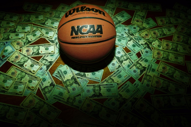 NCAA basketball surrounded by money