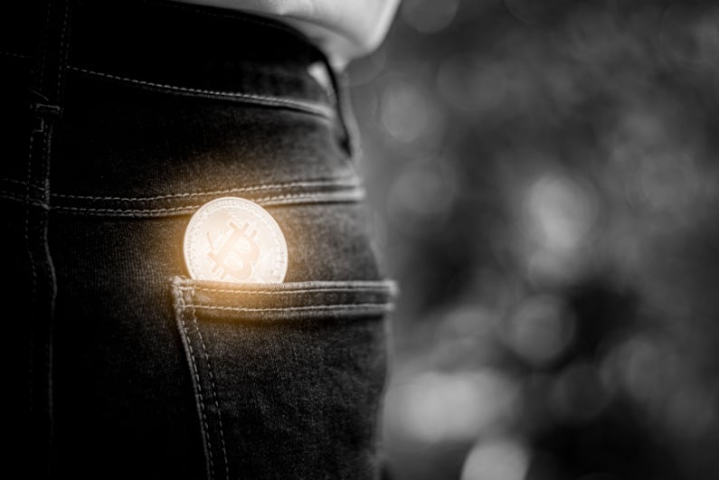 Physical Bitcoin in rear pocket of woman