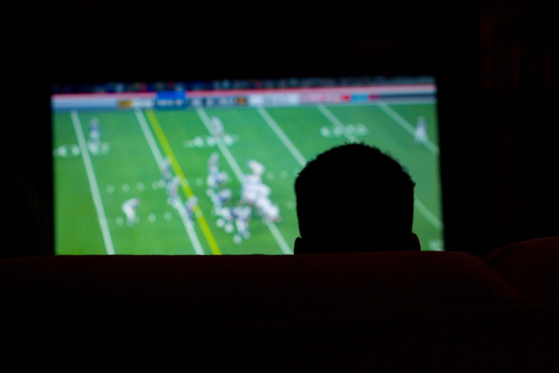 Person watching football on TV