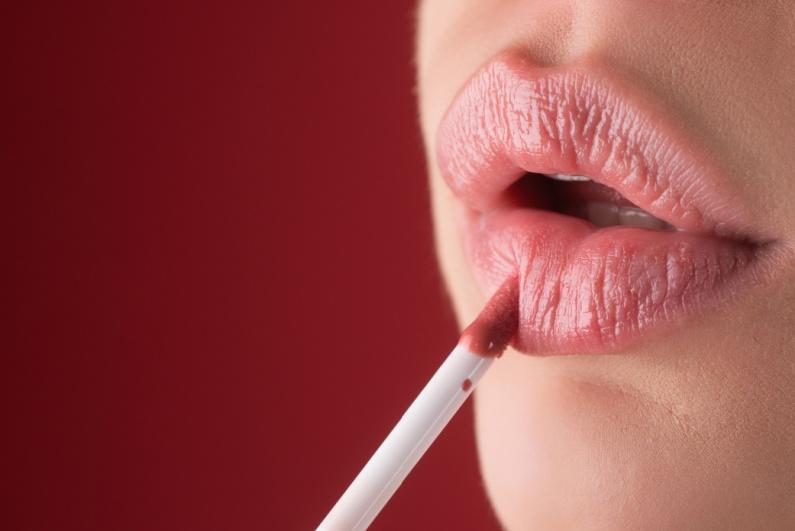 Woman applying lipstick