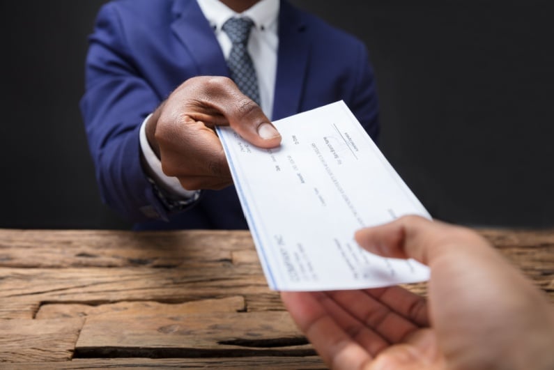 Businessman handing over check