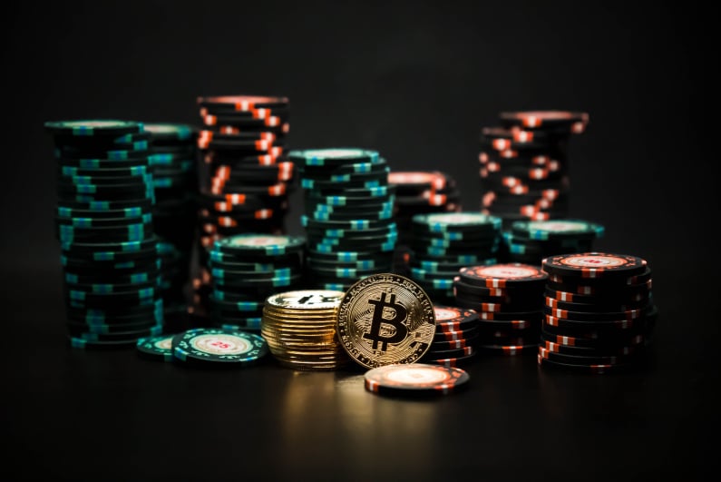 Physical Bitcoin illustration among casino chips