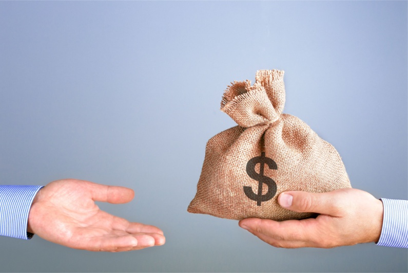 Person giving money in bag